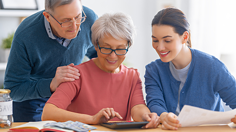 a young woman helping an older couple